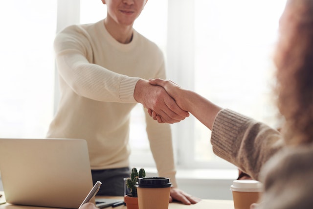 two people having a handshake