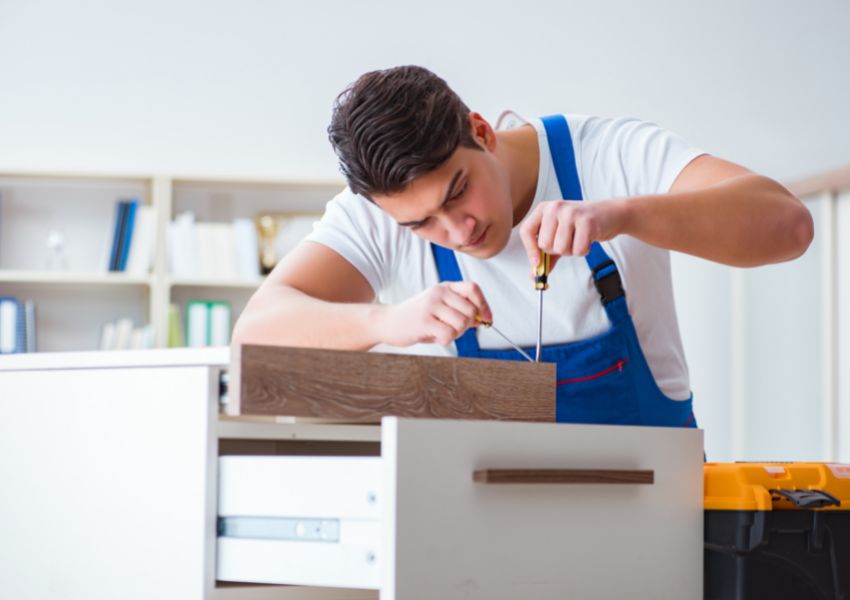 person-fixing-broken-furniture