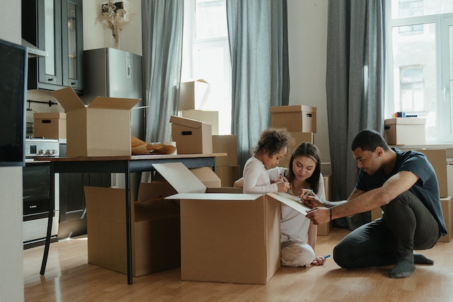 family moving in a new home and opening their boxes